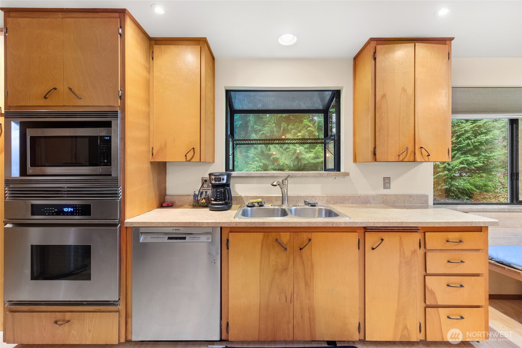 4617 200th Street Southeast Bothell, WA 98012 - Photo 8 of 39 a kitchen with stainless steel appliances a sink stove and cabinets