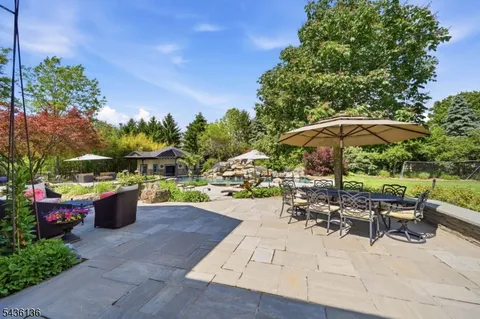 a view of a patio with furniture and a fire pit