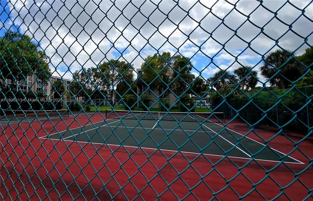 a kitchen with a sink a refrigerator a microwave and cabinets