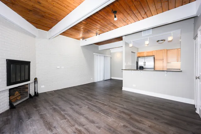 a view of a kitchen with wooden floor and a window