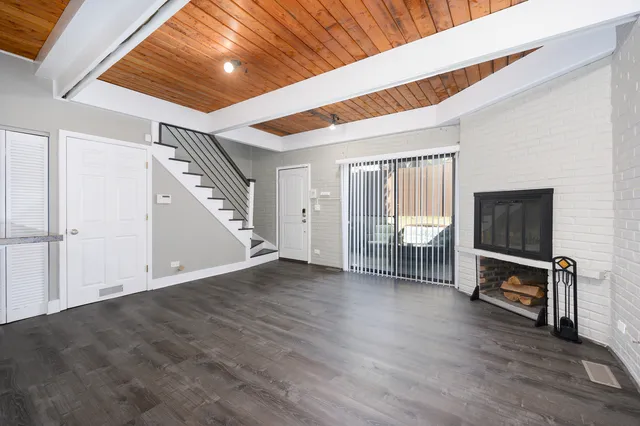 a view of a livingroom with wooden floor and furniture