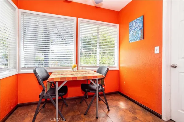 a bedroom with furniture and a large window