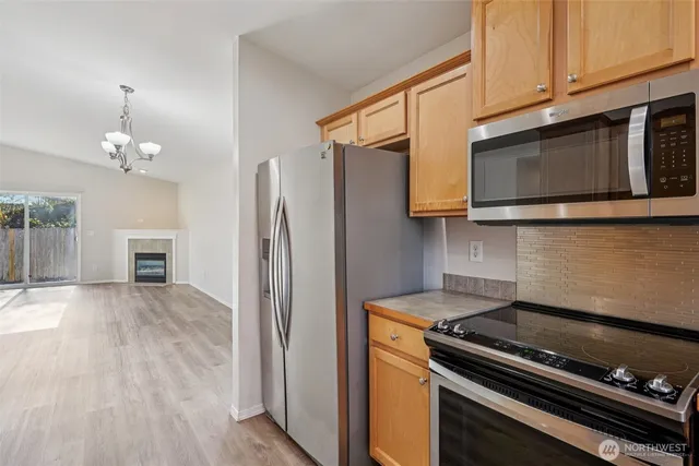 a kitchen with stainless steel appliances granite countertop a stove and a microwave