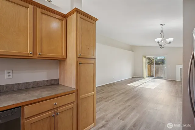 an empty room with wooden floor and cabinet