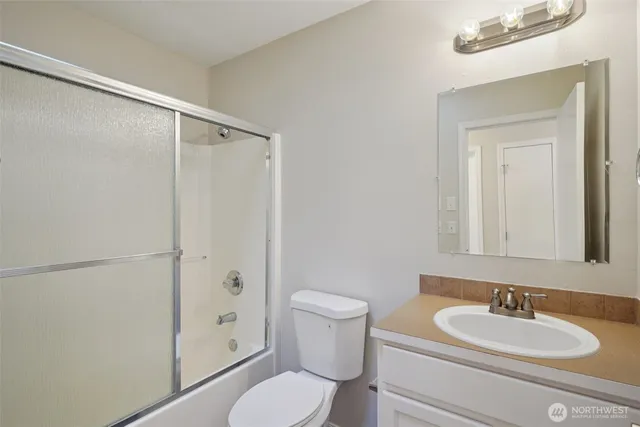 a bathroom with a toilet a sink and a mirror