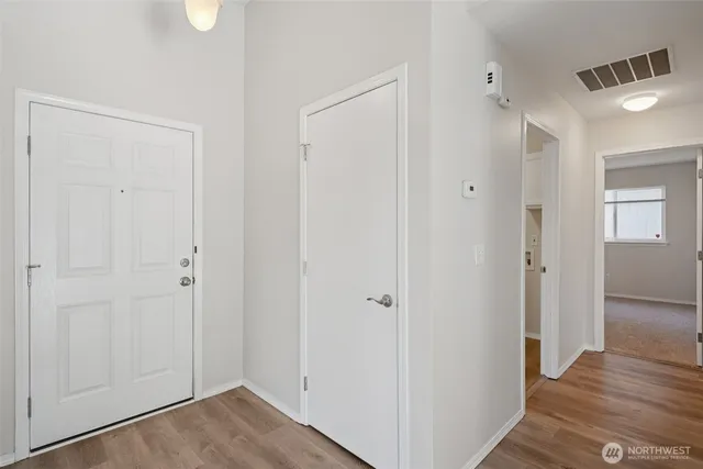 a view of a hallway with wooden floor