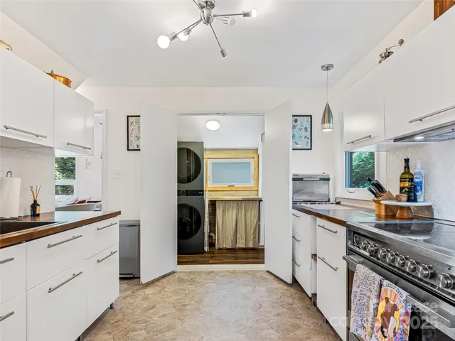 a kitchen with a stove and white cabinets