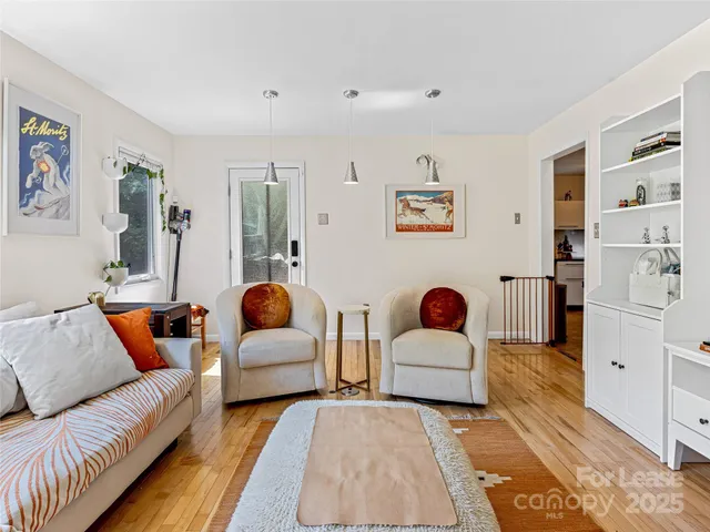 a bedroom with a large bed chandelier and a window