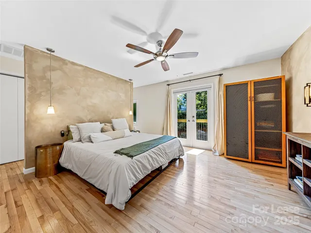 a bedroom with a large bed and flat tv