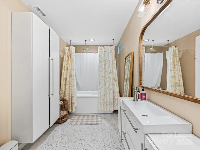 a bathroom with a shower curtain and a window