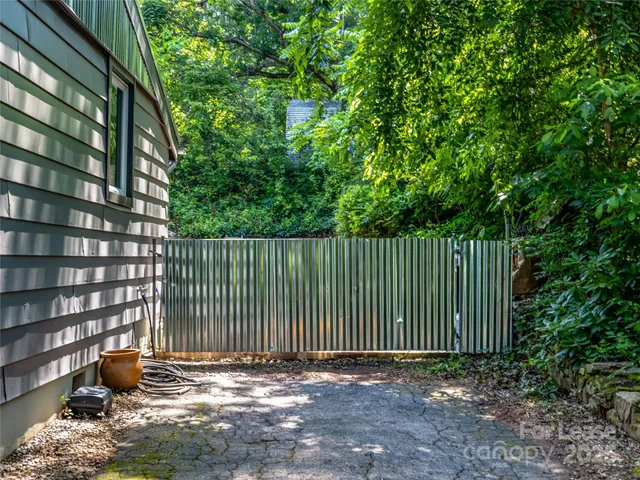a backyard of a house with oven and wooden fence