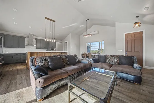 a living room with furniture a fireplace and a flat screen tv