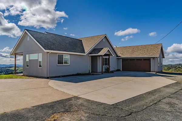 a front view of a house with parking space