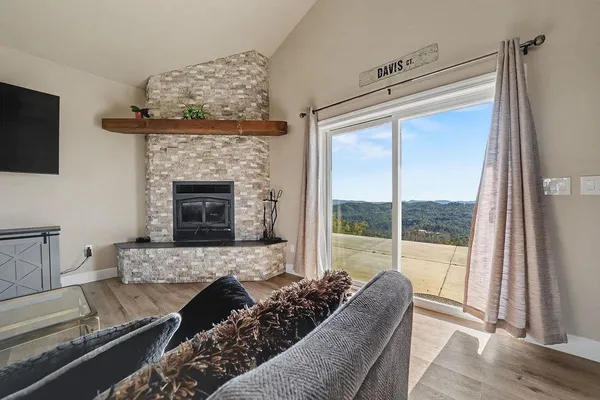 a living room with furniture a flat screen tv and a fireplace
