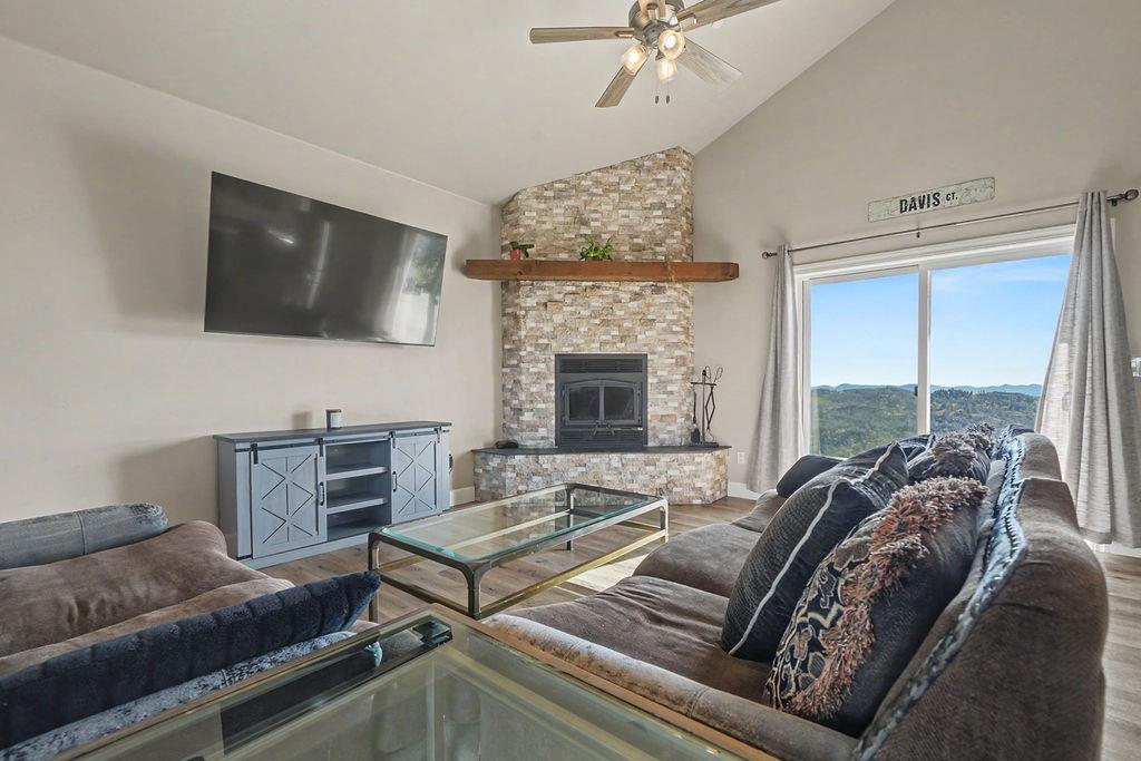 9515 Ham Luddy Road Mountain Ranch, CA 95246 - Photo 6 of 92 a living room with furniture a flat screen tv and a fireplace