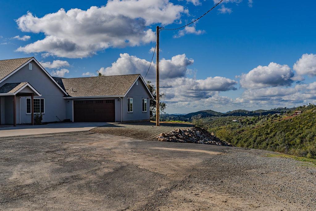 9515 Ham Luddy Road Mountain Ranch, CA 95246 - Photo 62 of 92 a front view of a house with a yard