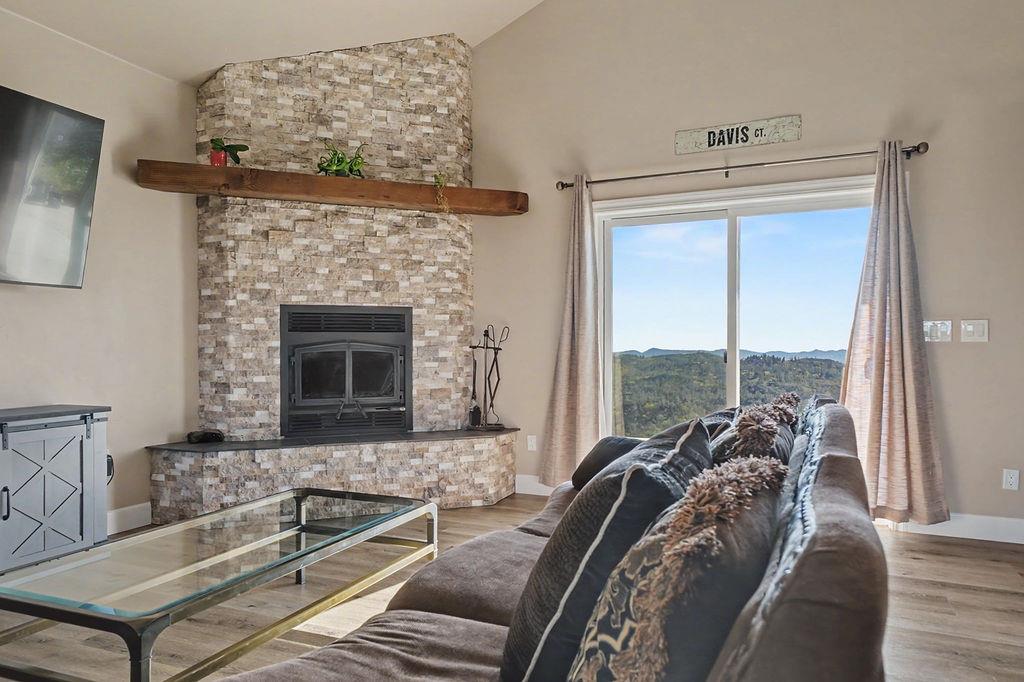 9515 Ham Luddy Road Mountain Ranch, CA 95246 - Photo 7 of 92 a living room with furniture large windows and a fireplace