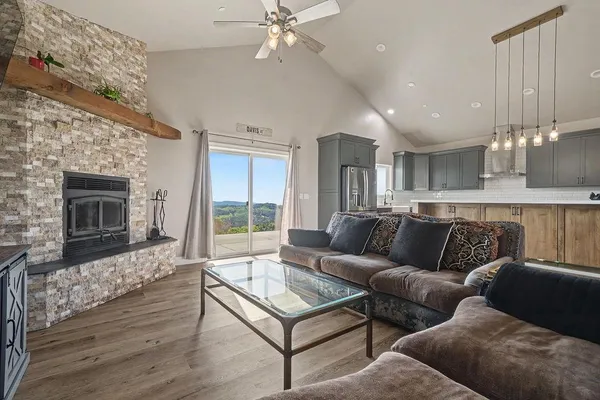 a living room with furniture a fireplace and a chandelier
