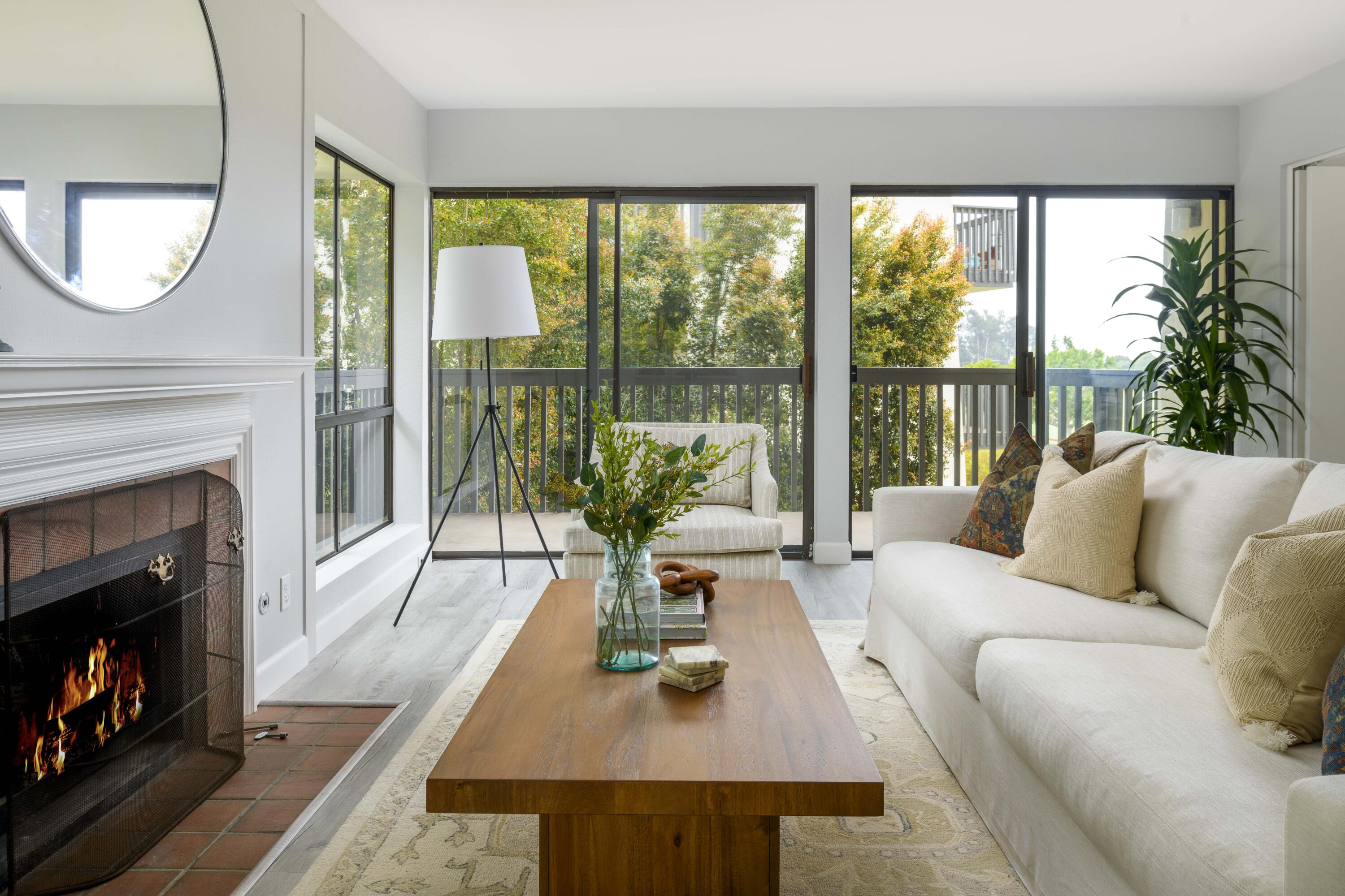 3375 Foothill Road, Unit 1121 Carpinteria, CA 93013 - Photo 13 of 24 a living room with furniture a large window and a fireplace