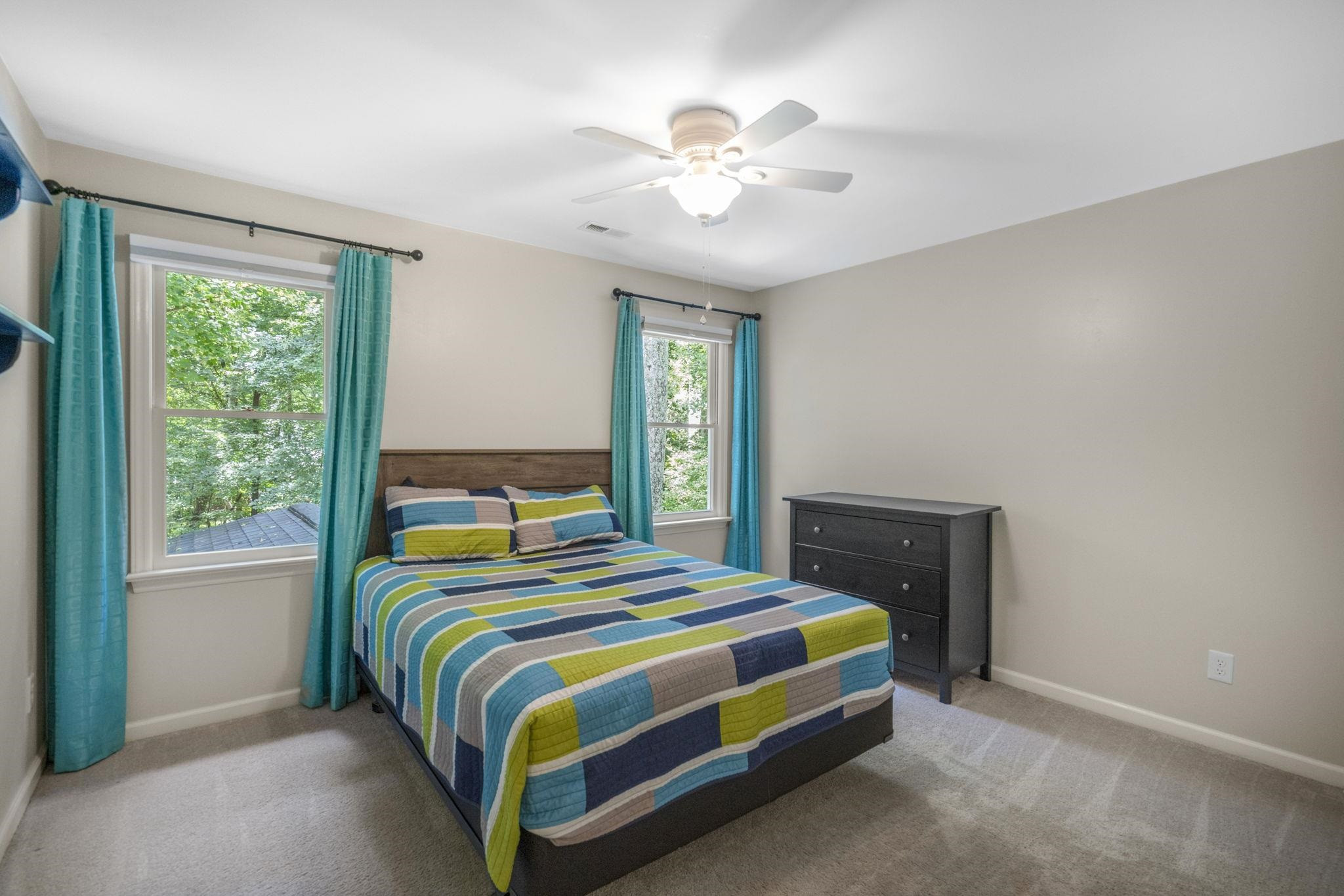 108 Rushingwater Drive Cary, NC 27513 - Photo 17 of 37 a bedroom with a bed and a chandelier