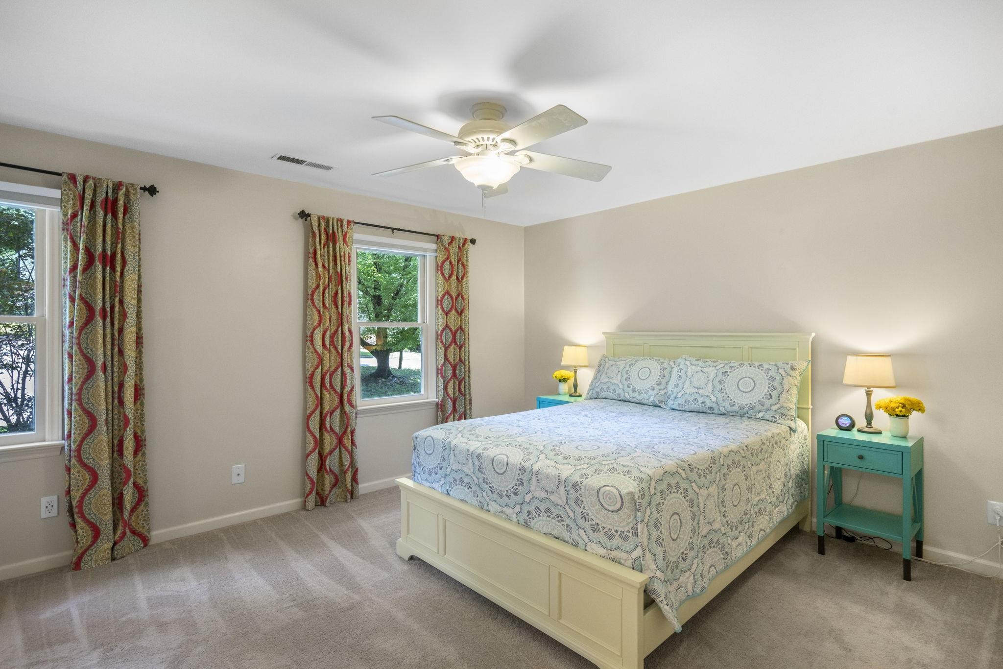 108 Rushingwater Drive Cary, NC 27513 - Photo 18 of 37 a bedroom with a bed and a chandelier