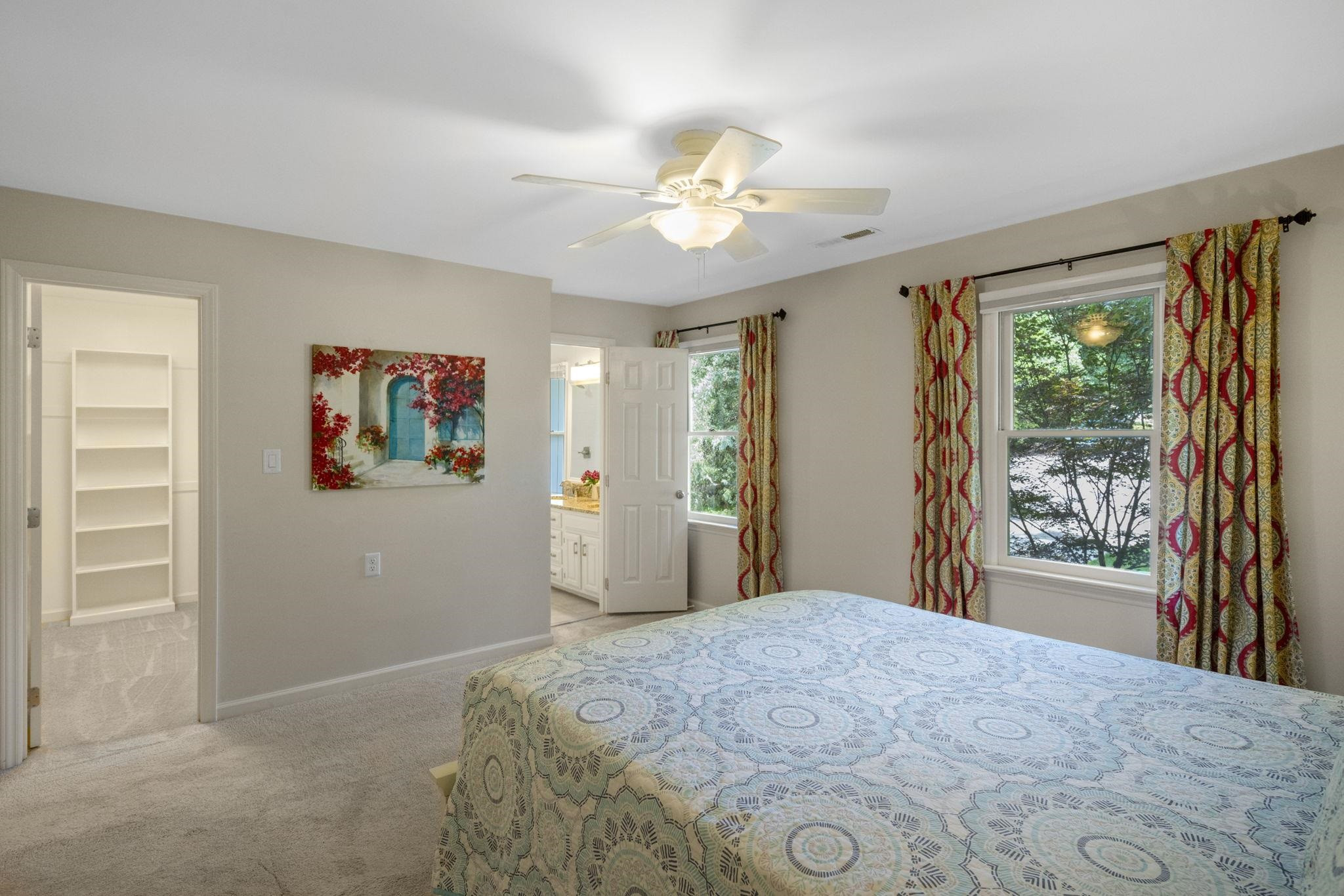 108 Rushingwater Drive Cary, NC 27513 - Photo 19 of 37 a bedroom with a large bed and a chandelier