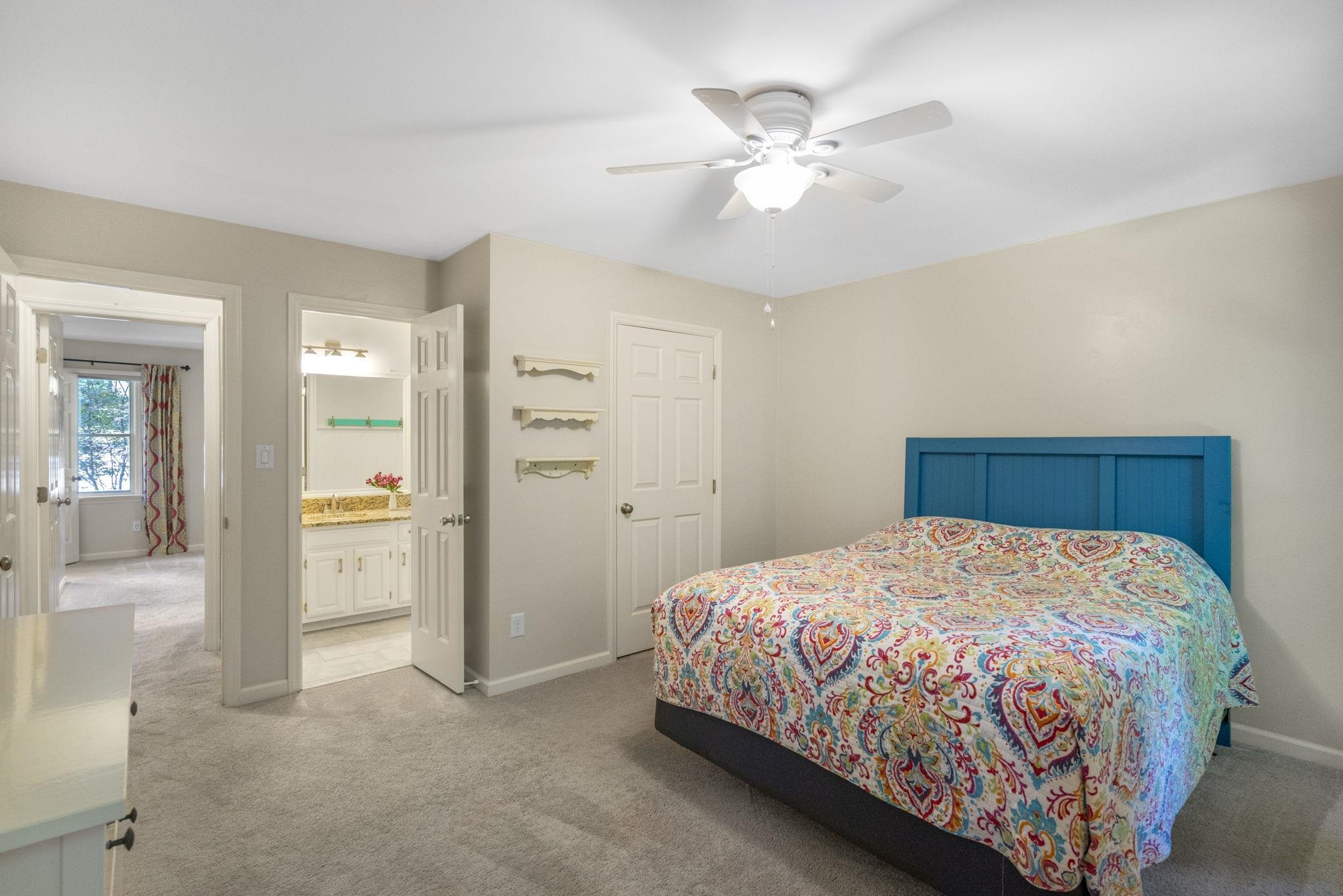 108 Rushingwater Drive Cary, NC 27513 - Photo 21 of 37 a bedroom with a bed and a chandelier