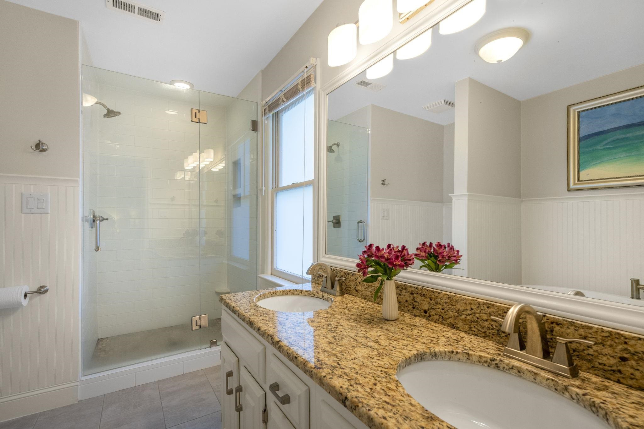 108 Rushingwater Drive Cary, NC 27513 - Photo 23 of 37 a bathroom with a granite countertop double vanity sink mirror and shower