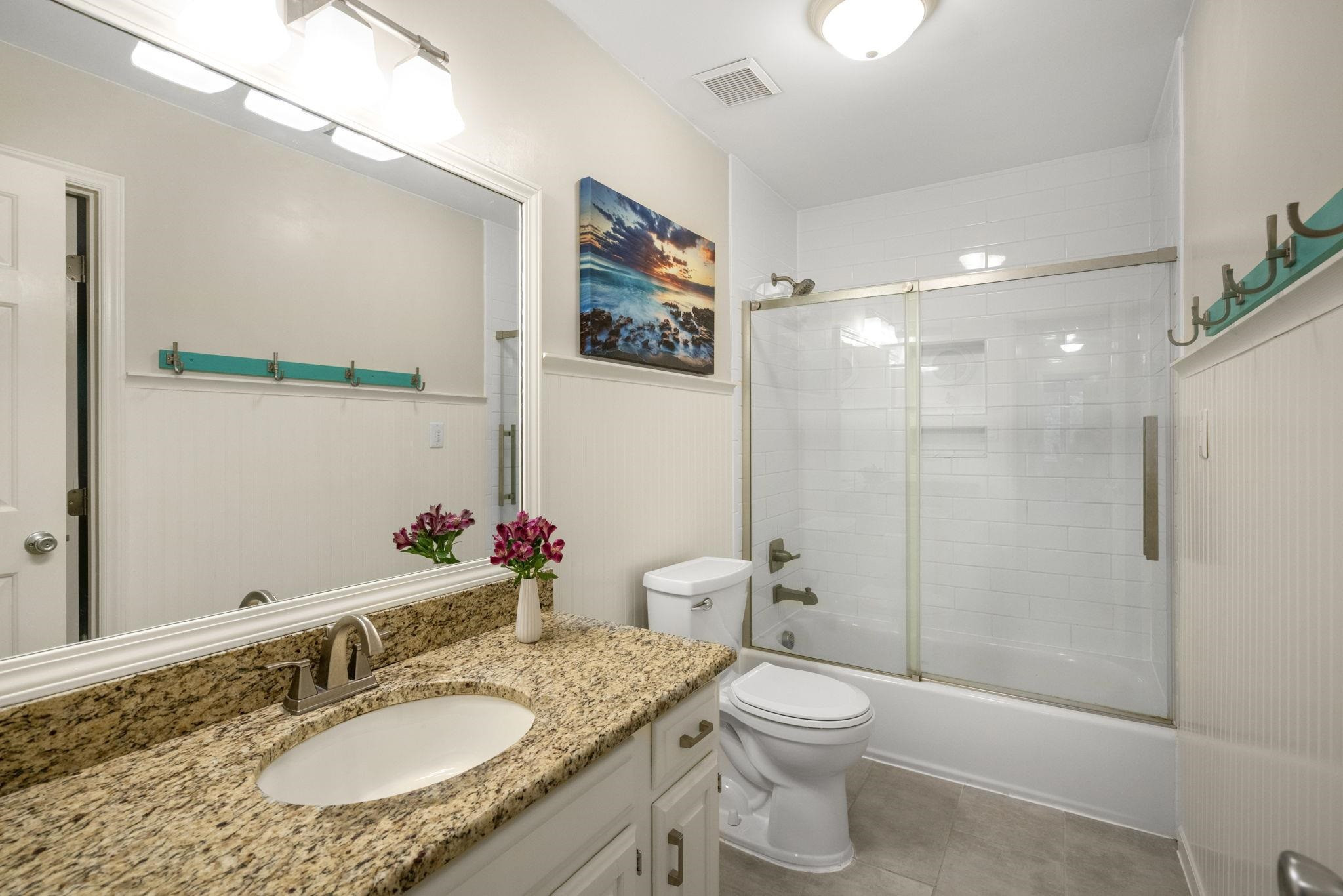 108 Rushingwater Drive Cary, NC 27513 - Photo 25 of 37 a bathroom with a granite countertop sink toilet a large mirror a shower and a mirror