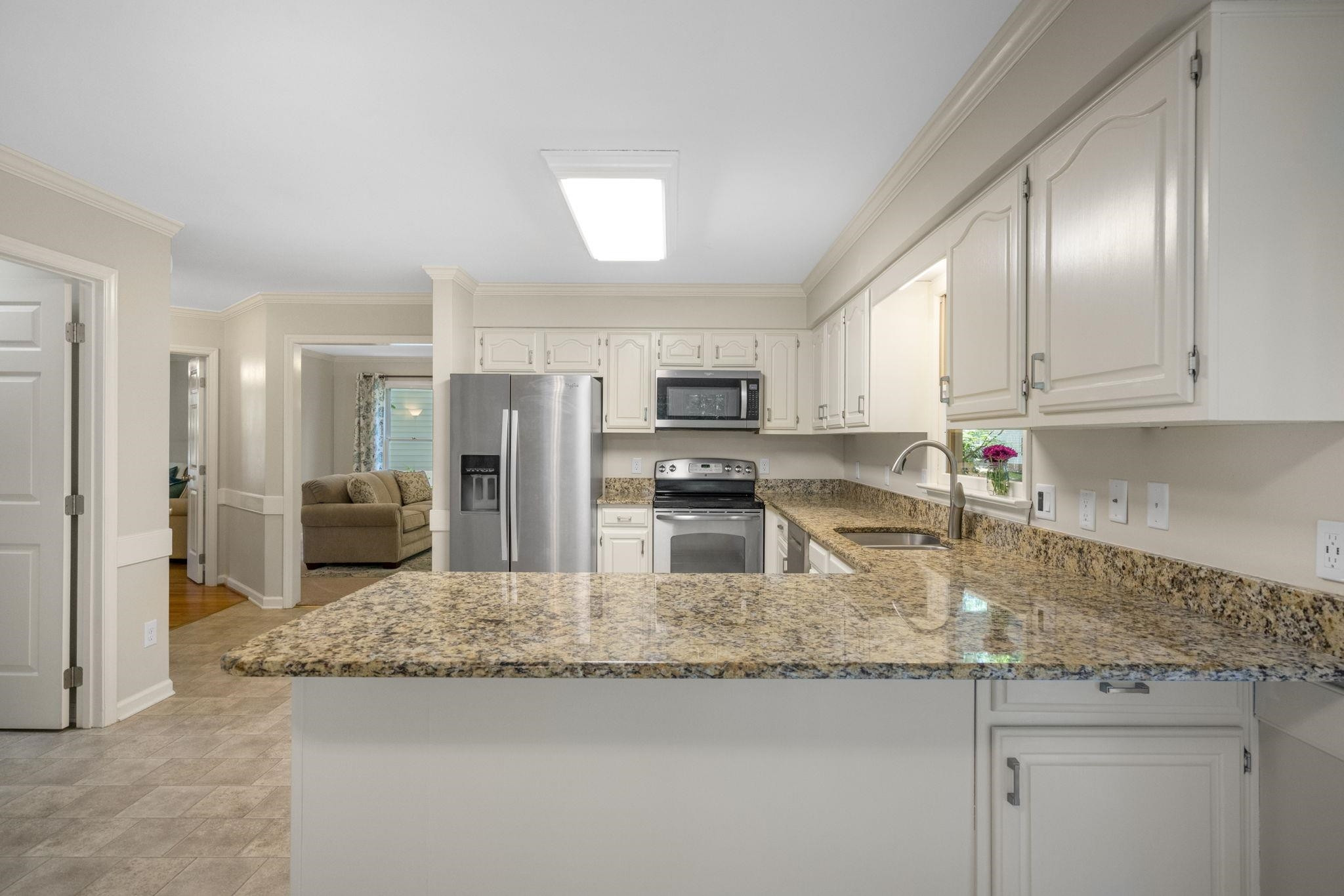 108 Rushingwater Drive Cary, NC 27513 - Photo 8 of 37 a kitchen with stainless steel appliances granite countertop a sink refrigerator and cabinets