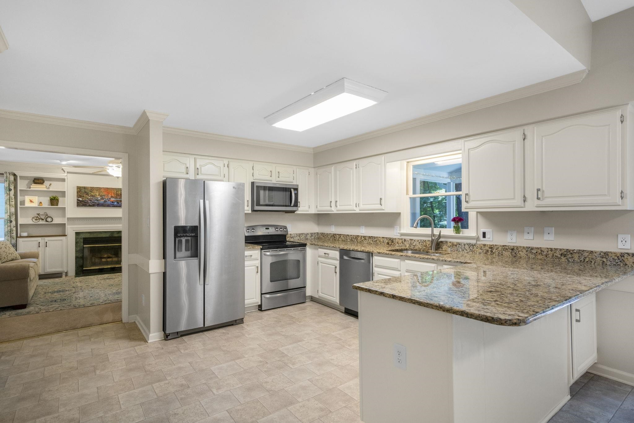 108 Rushingwater Drive Cary, NC 27513 - Photo 9 of 37 a kitchen with stainless steel appliances granite countertop a refrigerator sink and stove
