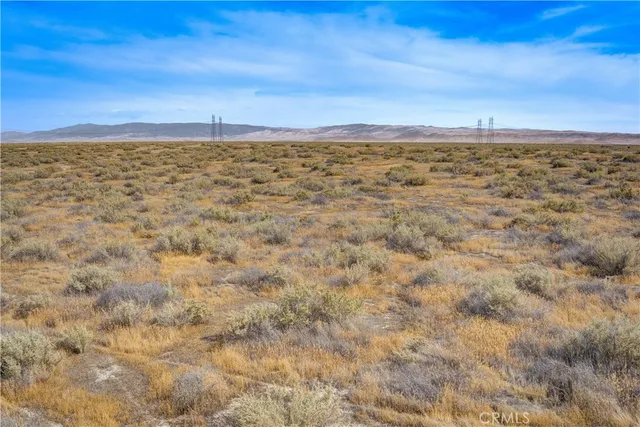 a view of an ocean beach and mountain