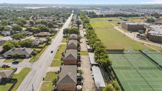 an aerial view of residential houses with outdoor space