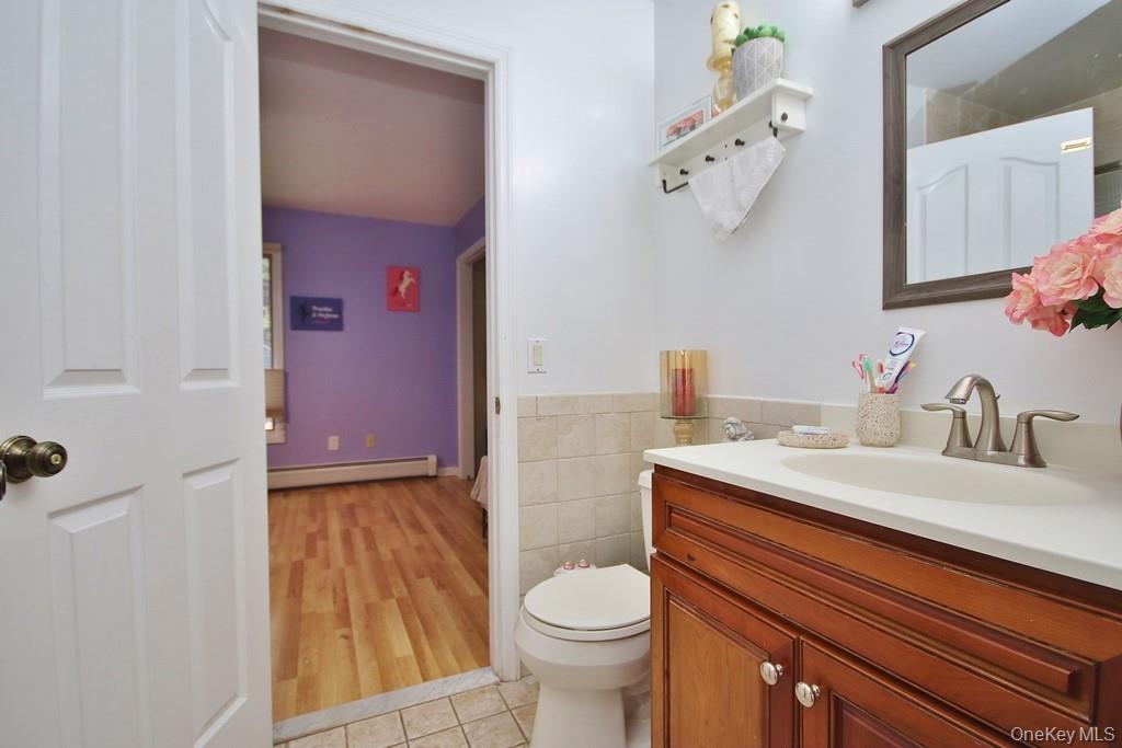 7 Park Place Chester, NY 10918 - Photo 24 of 48 a bathroom with a granite countertop sink mirror vanity and toilet