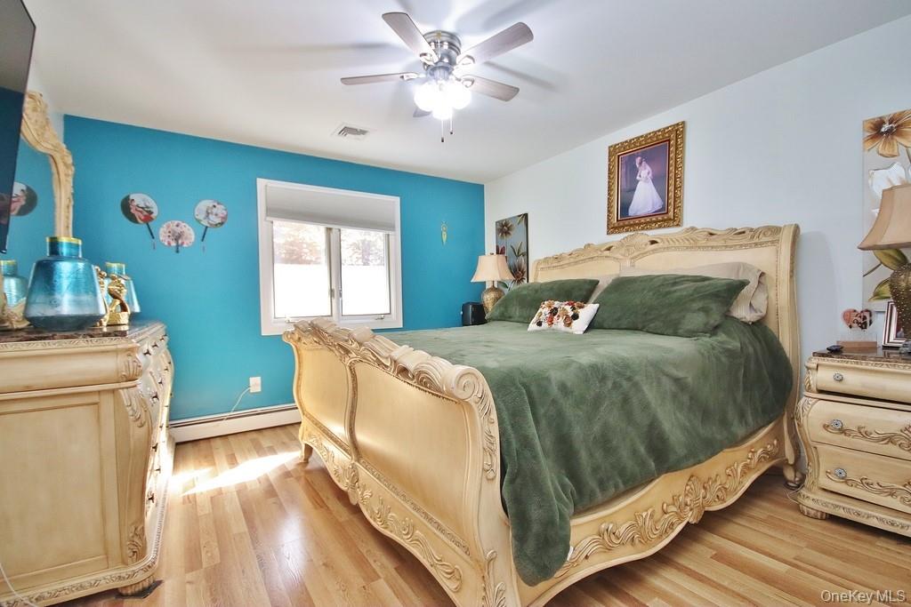 7 Park Place Chester, NY 10918 - Photo 32 of 48 a bedroom with a large bed and a chandelier