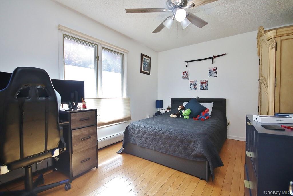 7 Park Place Chester, NY 10918 - Photo 34 of 48 a bedroom with a bed and wooden floor