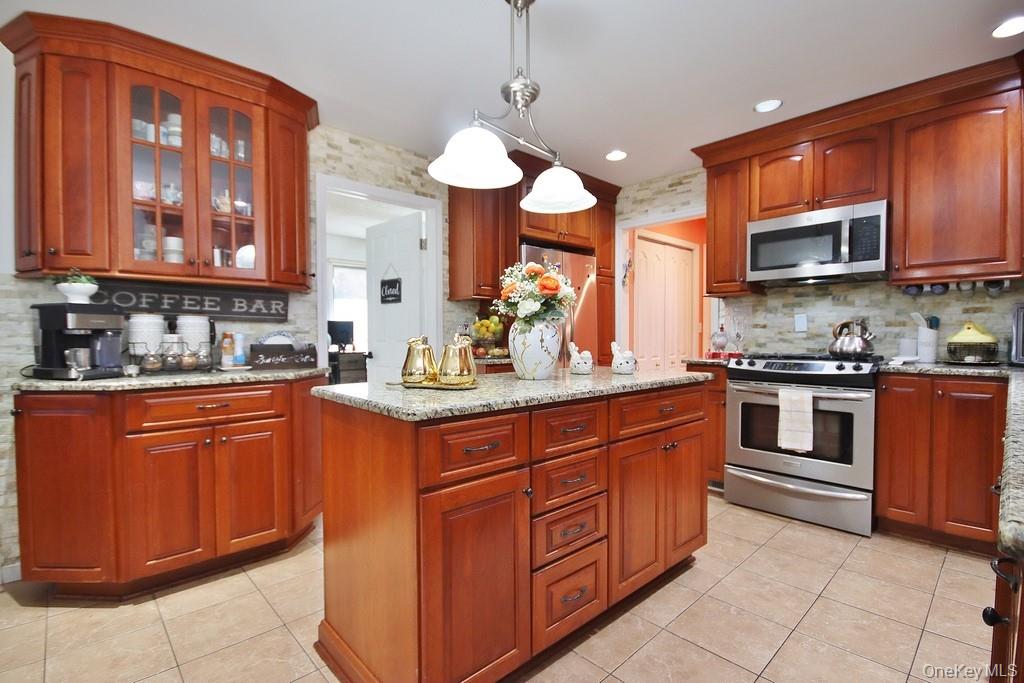 7 Park Place Chester, NY 10918 - Photo 6 of 48 a kitchen with stainless steel appliances granite countertop wooden cabinets a sink and a stove