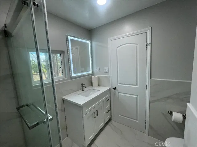 a bathroom with a sink toilet and shower