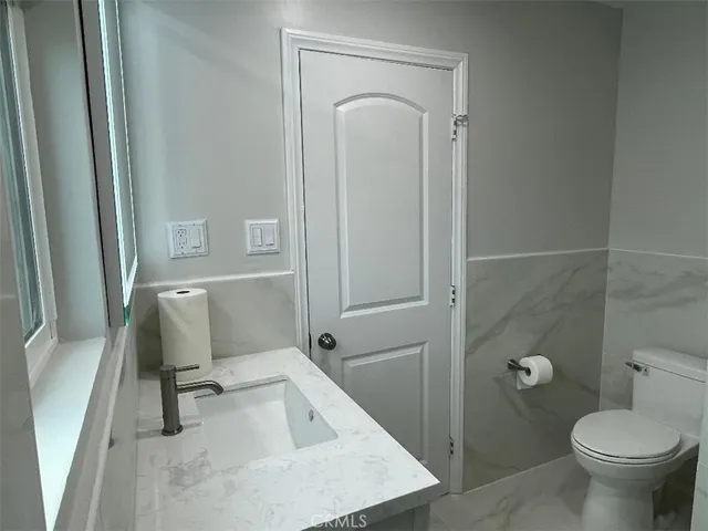 a bathroom with a shower sink and mirror