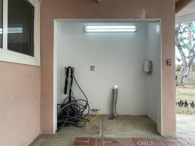 a view of a livingroom with an empty space and a large window