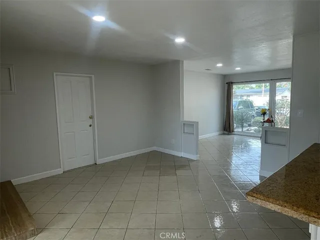 an empty room with windows and entrance