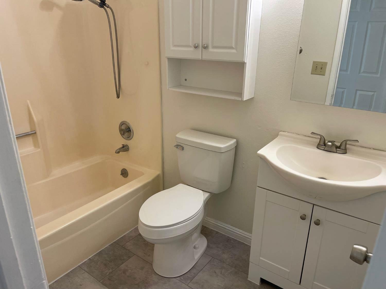 3101 Wyatt Way Modesto, CA 95350 - Photo 12 of 17 a white toilet sitting next to a bath tub