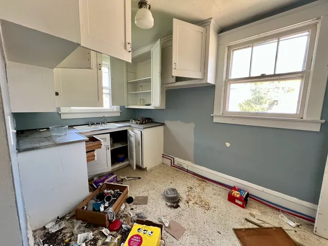 a room with furniture a flat screen tv and a window