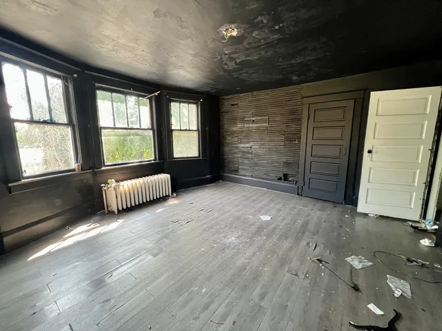 a spacious bedroom with a bed and a large window