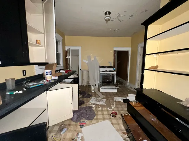 a kitchen with sink refrigerator and stove