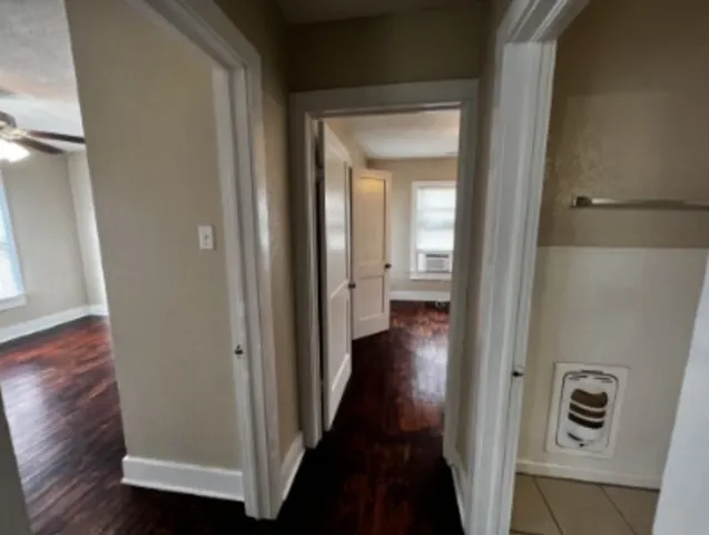 a view of a hallway with wooden floor