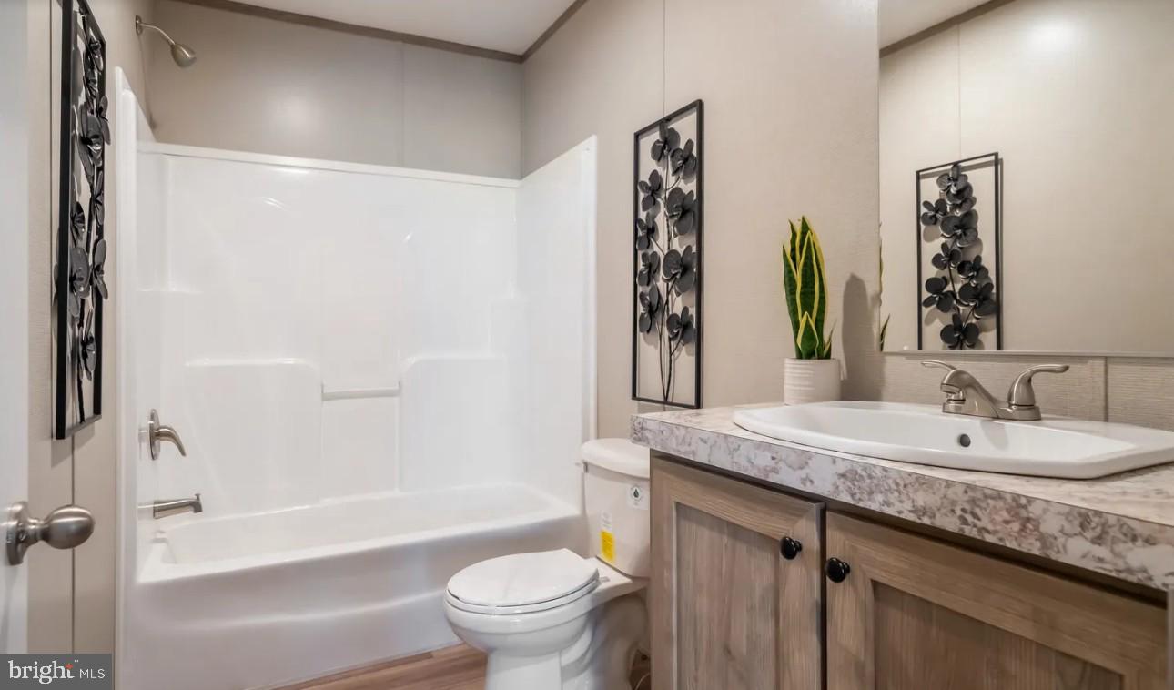 1672 Kents Mill Road Louisa, VA 23093 - Photo 11 of 18 a bathroom with a granite countertop sink a toilet and shower