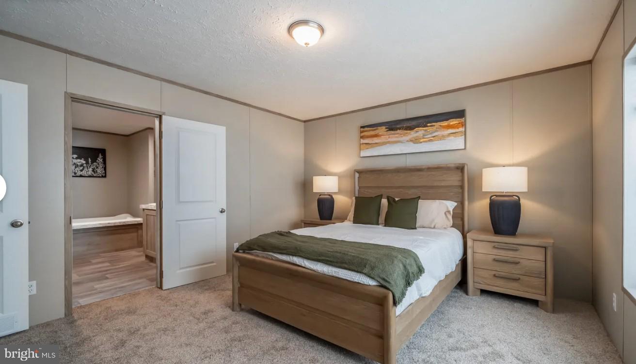 1672 Kents Mill Road Louisa, VA 23093 - Photo 10 of 18 a bedroom with a bed and a chandelier