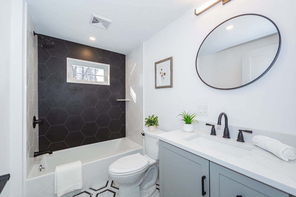 12 Bay State Road Natick, MA 01760 - Photo 13 of 35 a bathroom with a sink a toilet and shower