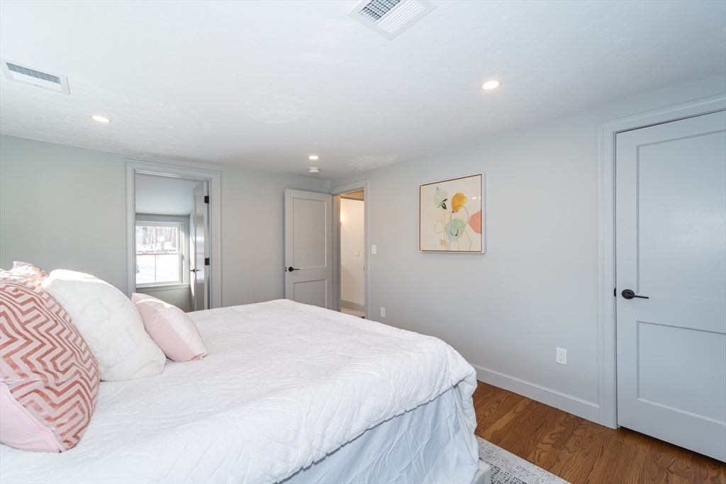 12 Bay State Road Natick, MA 01760 - Photo 20 of 35 a bedroom with a large bed and a chandelier